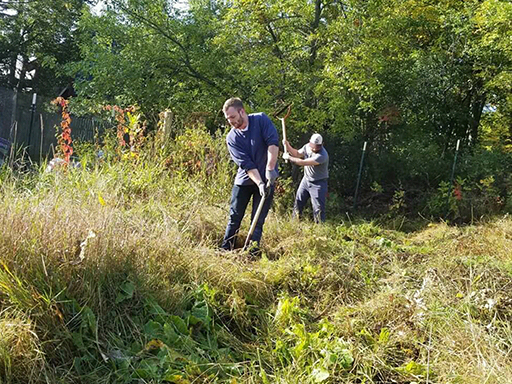 AmeriCorps VISTA volunteers work in community garden