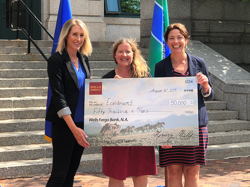 Mayor Emily Larson awards Jodi Slick a grant check for $50,000 for the Lincoln Park Community Solar Garden.