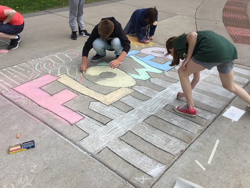 Lincoln Park Middle School students create chalk art.