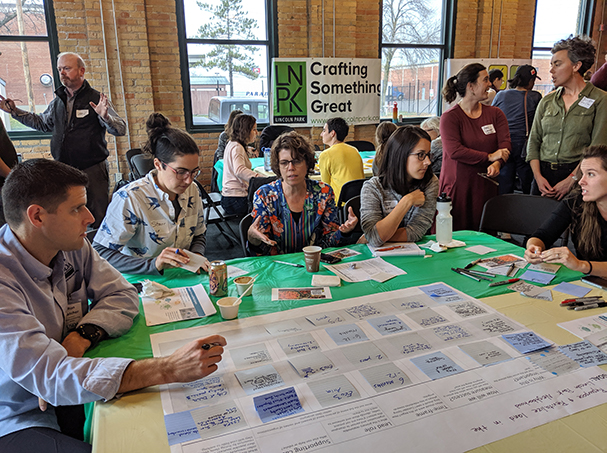 Community members discuss around tables during Local Foods Summit