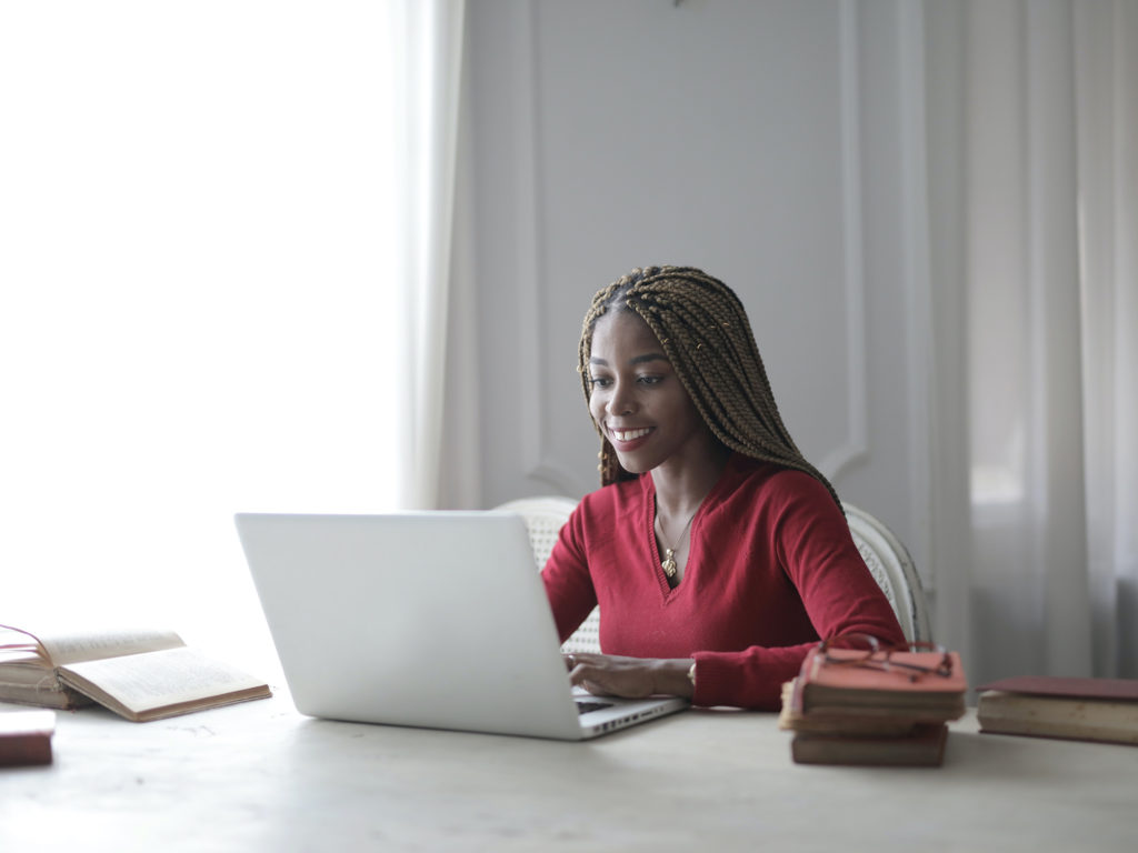 Stock image of person using a laptop at a table