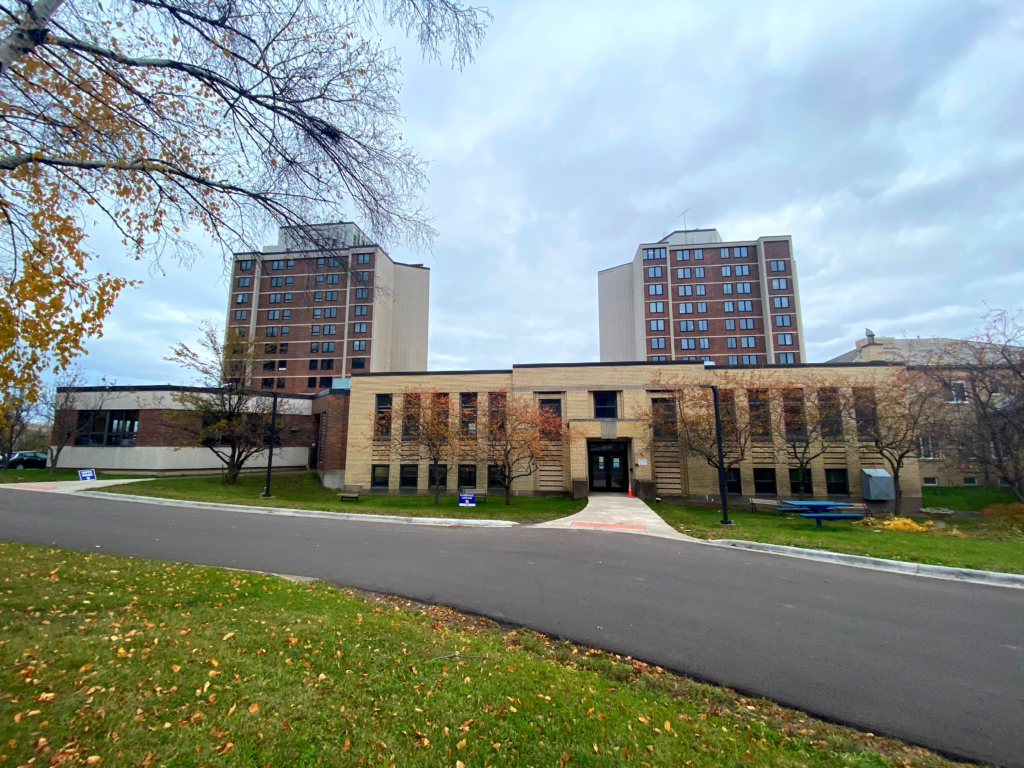 Photo of the Lincoln Park Community Center, showing both entrances and the Midtowne Manor towers behind.