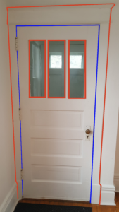 Internal door at entry of a home. There are blue lines around the outside of the door itself. There are red lines around the trim of the door and around each of the three windows in the door.