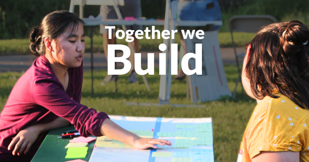 Two people sit across from each other at a picnic table covered in papers and plans. Text reads "Together we build," the Eco3 logo is at the bottom left.