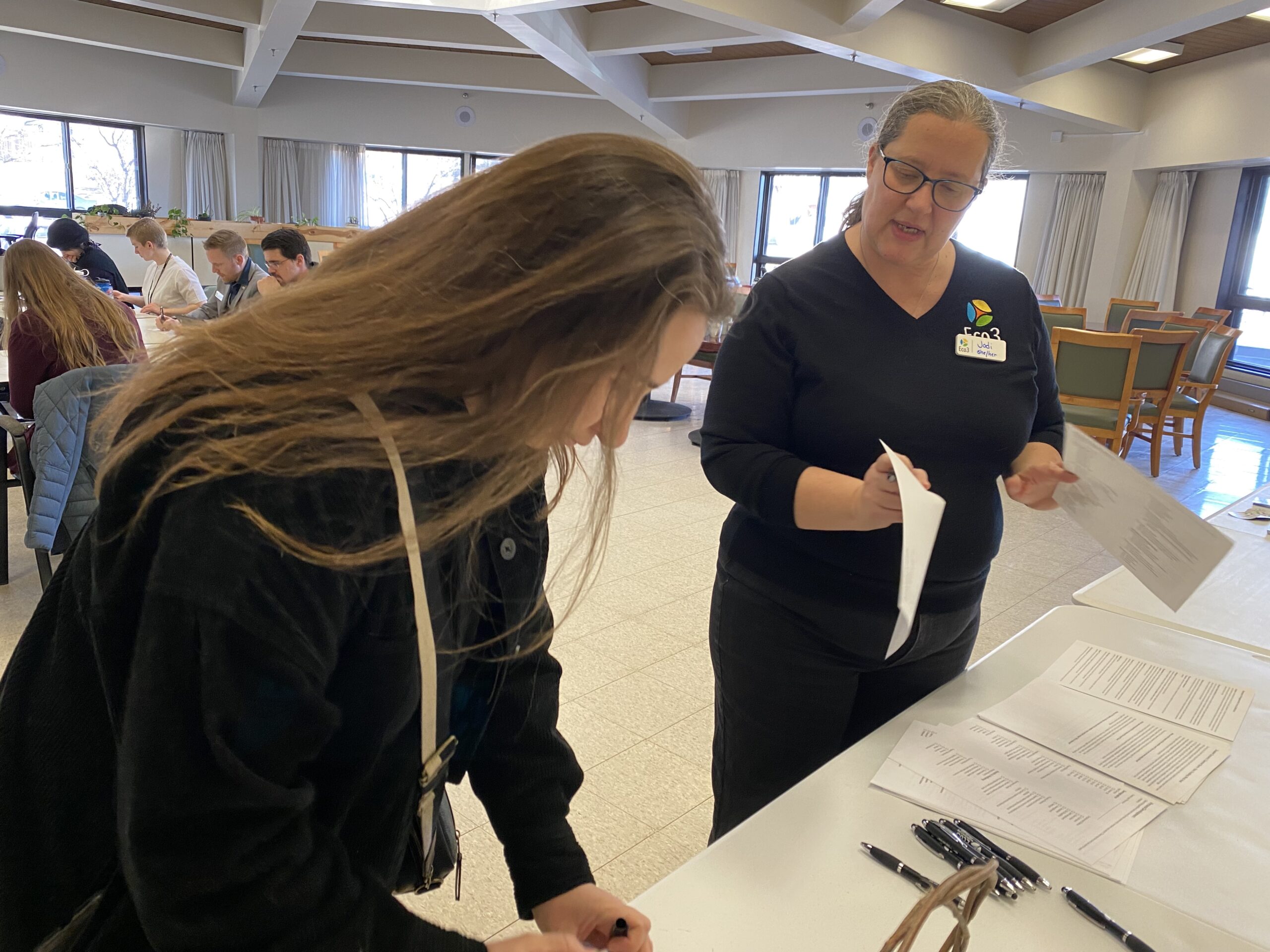 Two people look over a piece of paper together