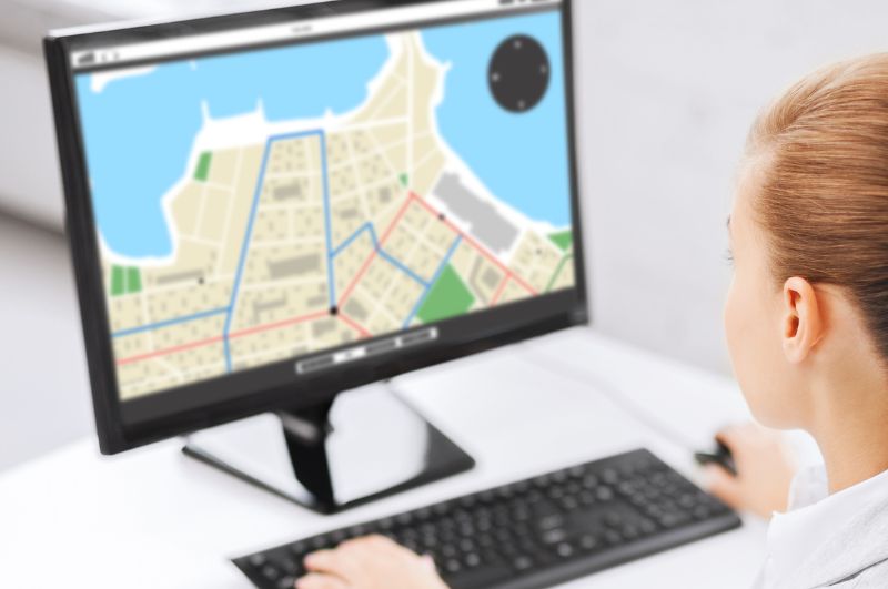 stock image of person looking at map on computer